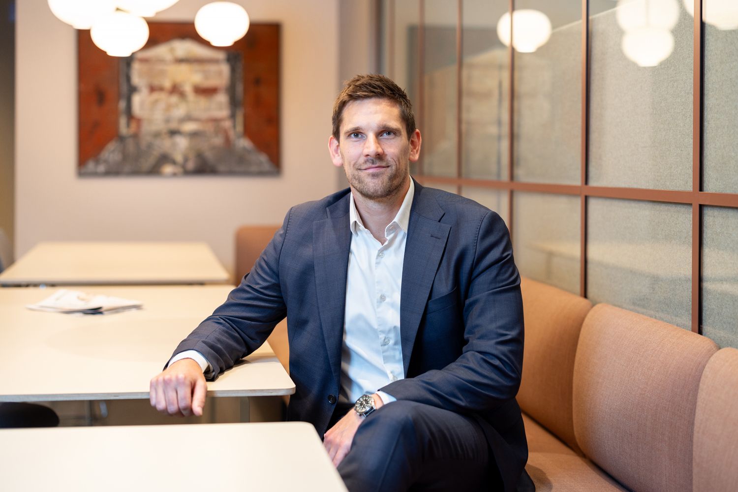 Mann i dress smiler i kamera